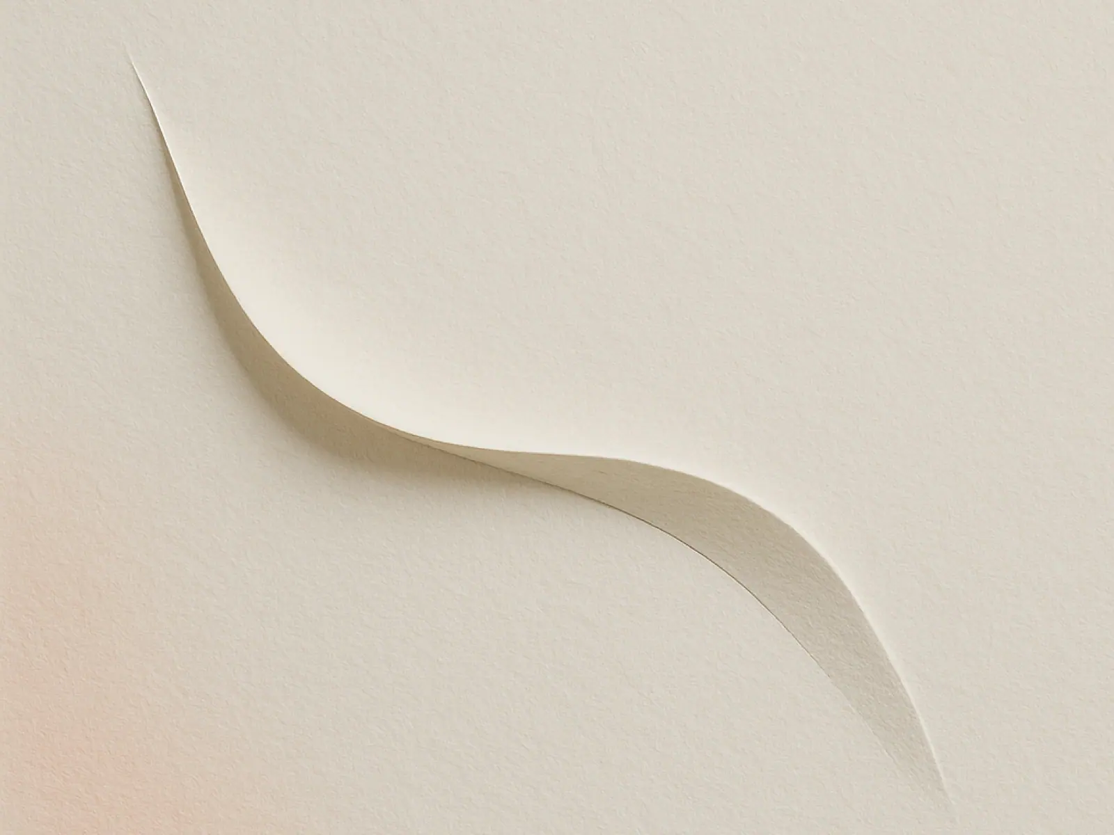 Curved paper cut on a beige background resembling a sperm shape, used to represent sperm donation and queer family building.
